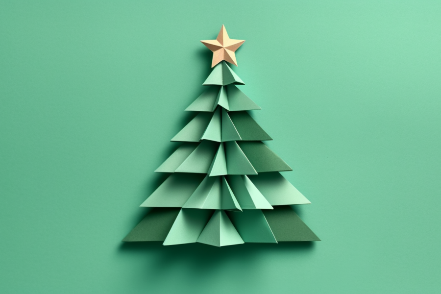 A paper Christmas tree with a star on top is featured in this image. The tree is made of folded green paper and is placed against a green background. The intricate folds of the paper create a realistic tree shape, and the star on top adds a festive touch. The colors in the image include shades of green, such as #94d4b0, #1a5137, and #55a17e. The overall theme of the image is Christmas, with a focus on decorating and creating a handmade holiday decoration. The image is high quality, with a resolution of 1456x816.