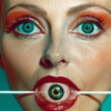 In this image, we see a young woman with striking features. She has a vivid red lip and is holding a fake eyeball on a stick in front of her face. The woman appears to be in her late twenties and has a feminine appearance. She is the main focus of the image, with her face taking up a significant portion of the frame. The woman''s expressive eyes stand out, complemented by her bold lip color. The overall color scheme of the image includes shades of brown, green, and blue. The woman''s hand holding the fake eyeball is also visible, adding an element of playfulness to the scene.