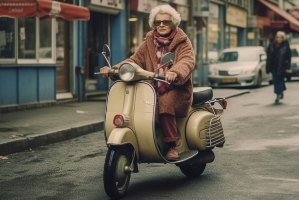 In this image, we see a woman riding a moped down a city street. The woman is wearing a brown coat and a hat, and she has a scarf around her neck. She is confidently navigating the street on her beige scooter. In the background, there is a man walking with a red umbrella. The street is lined with buildings, cars, and a van. The scene captures urban life with its hustle and bustle. The colors in the image are primarily earth tones, adding to the cityscape aesthetic. This image conveys a sense of movement and activity in an urban setting.