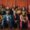 A group of masked individuals are sitting on chairs in a room. The group consists of both men and women, all wearing various types of masks. One woman, estimated to be around 32 years old, is seated in the center, wearing a mask on her head. The individuals are dressed in a mix of formal and casual attire, with some wearing ties and leather shoes. The scene gives off a vibe of a mysterious gathering or a team of masked wrestlers. The room is dimly lit, adding to the mysterious and intriguing atmosphere of the image.